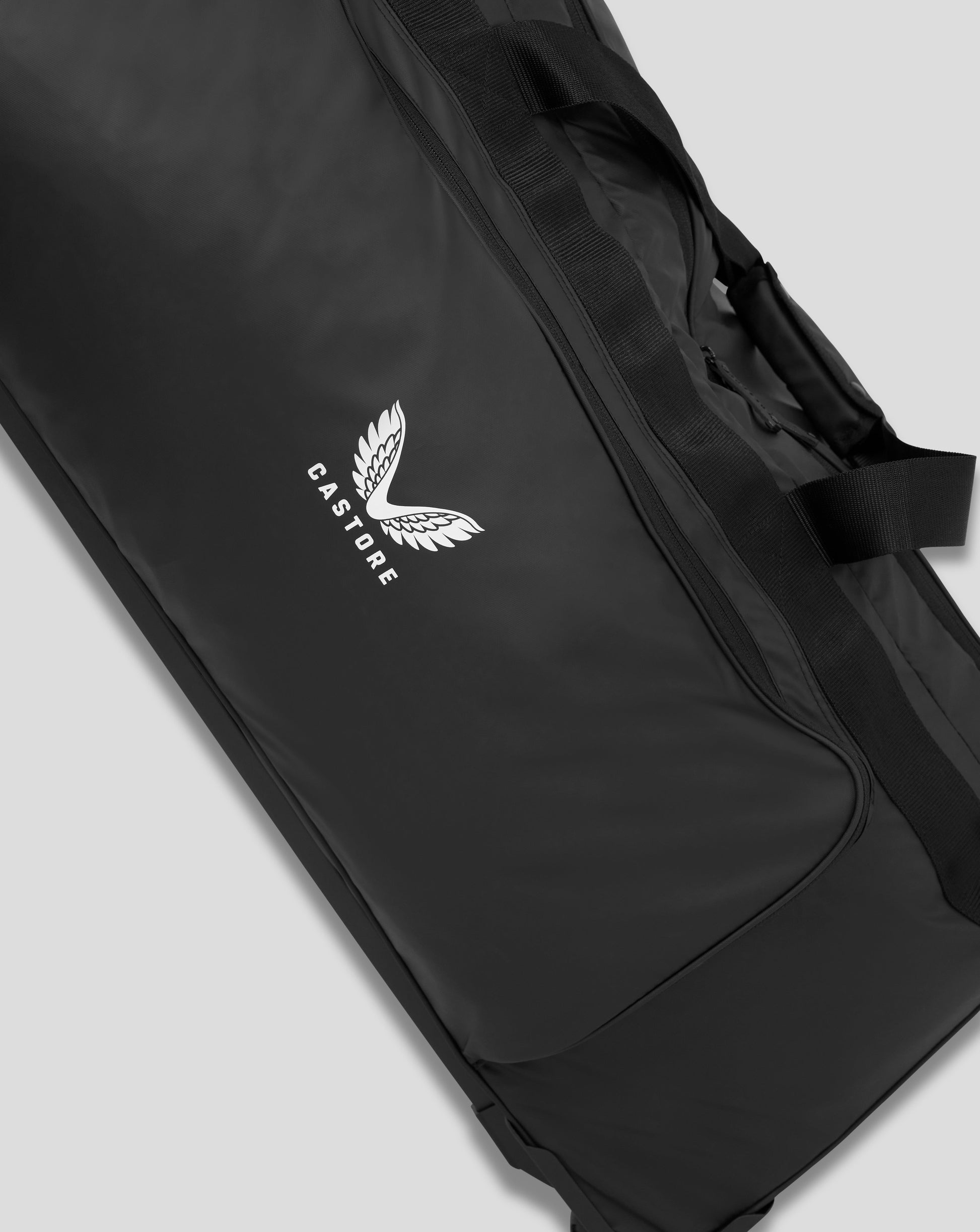 Close-up of side of black Castore bag showing webbing strap and top zipper with logo