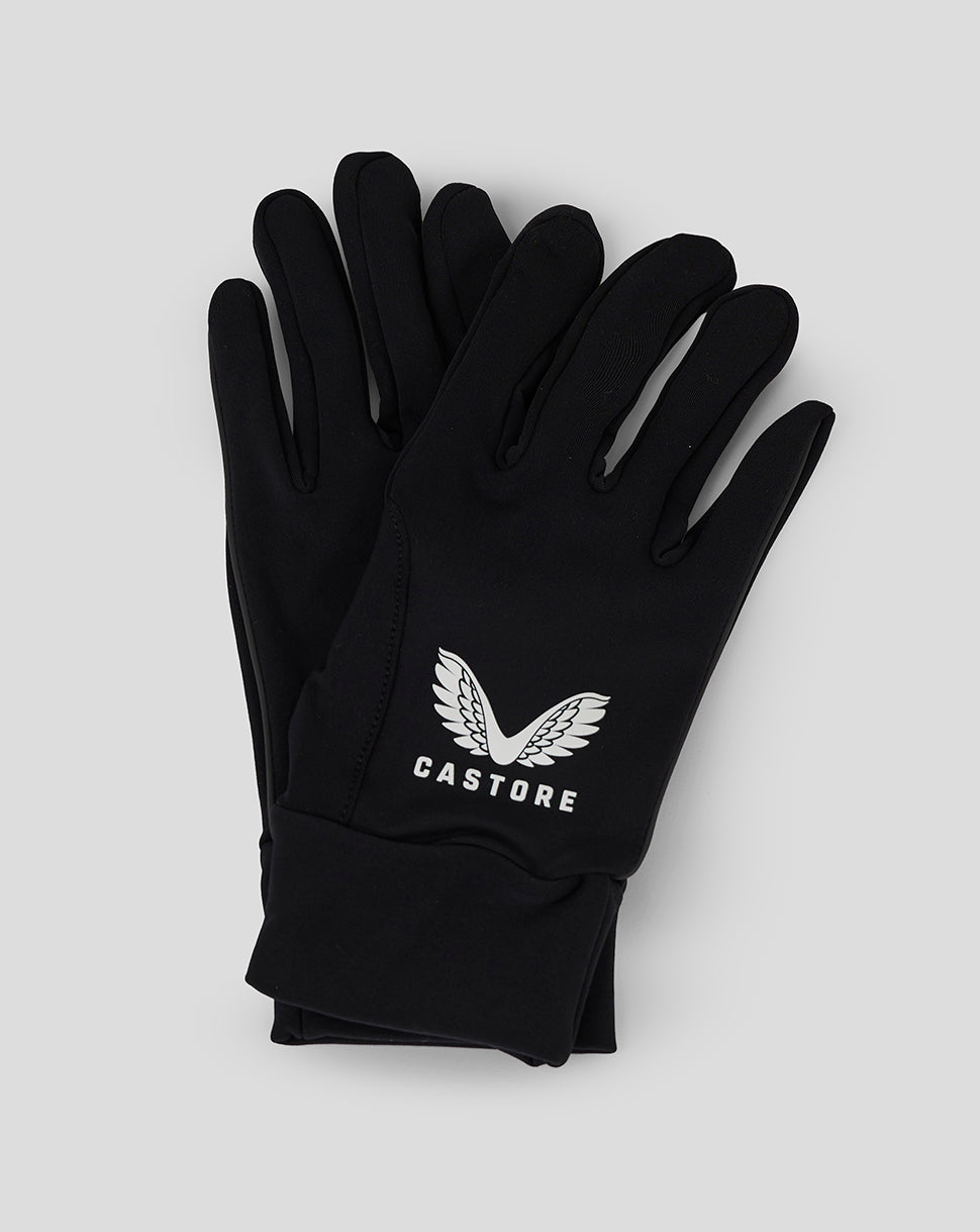 Black Castore gloves with white logo laid flat on a light background.