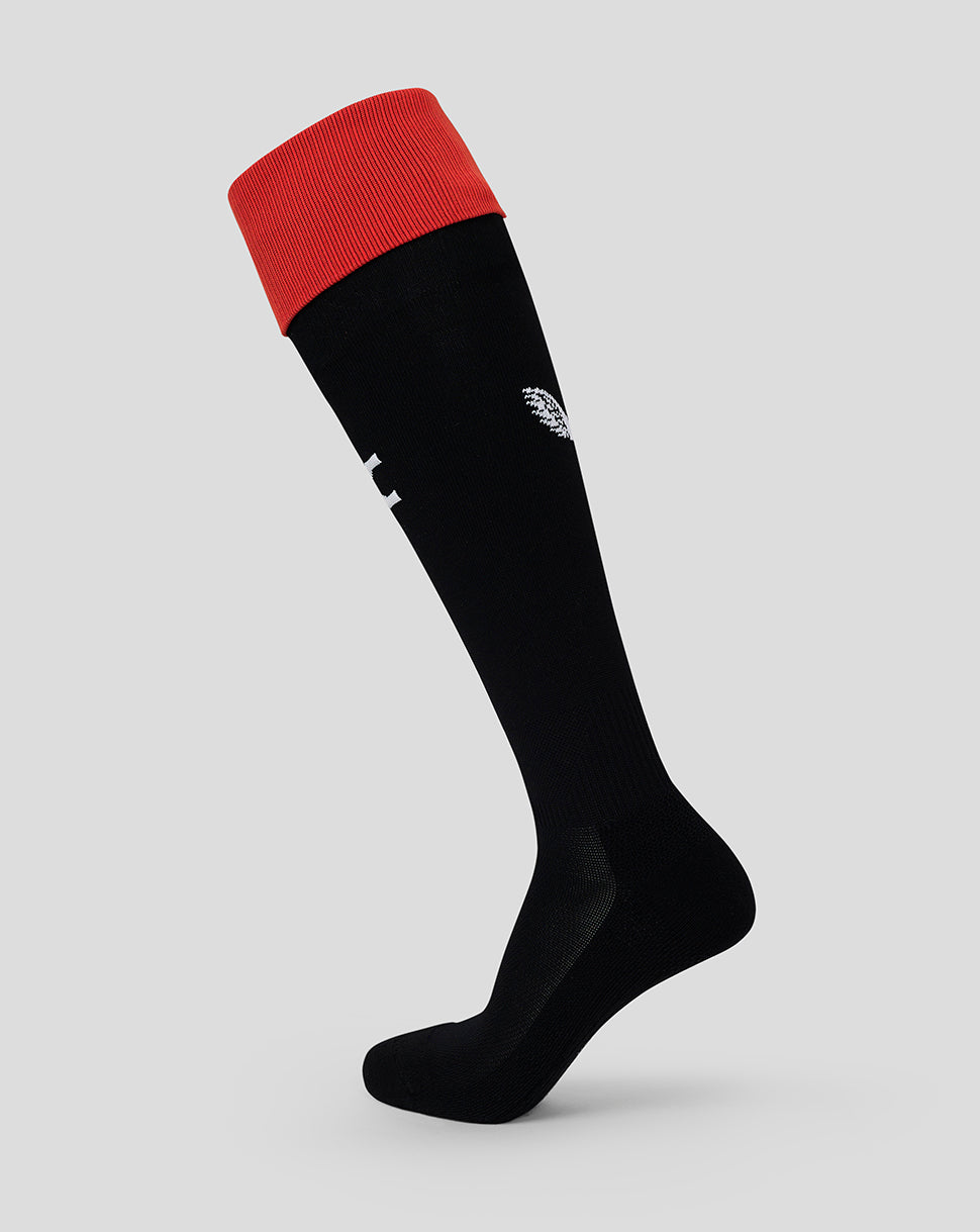 Black knee-high sock with red cuff and white logos on the calf