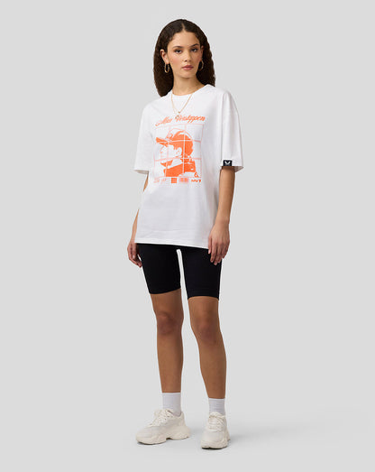 Female model in oversized white Max Verstappen T shirt with orange grid graphic on the front.