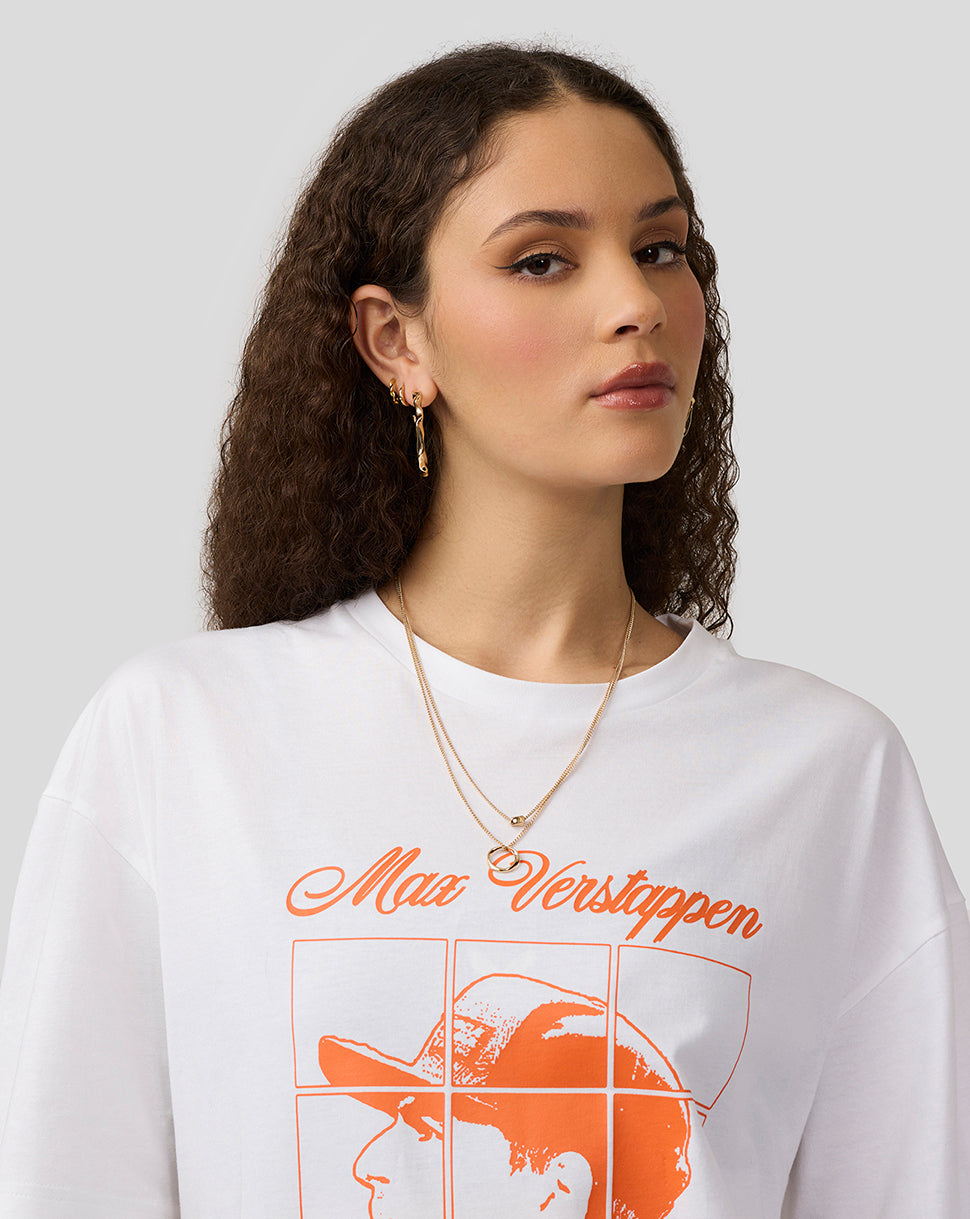 Female model wearing white Max Verstappen puzzle T shirt with orange front graphic.