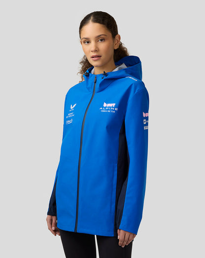 Female model wearing blue BWT Alpine water resistant jacket with hood and sponsor logos on the chest.