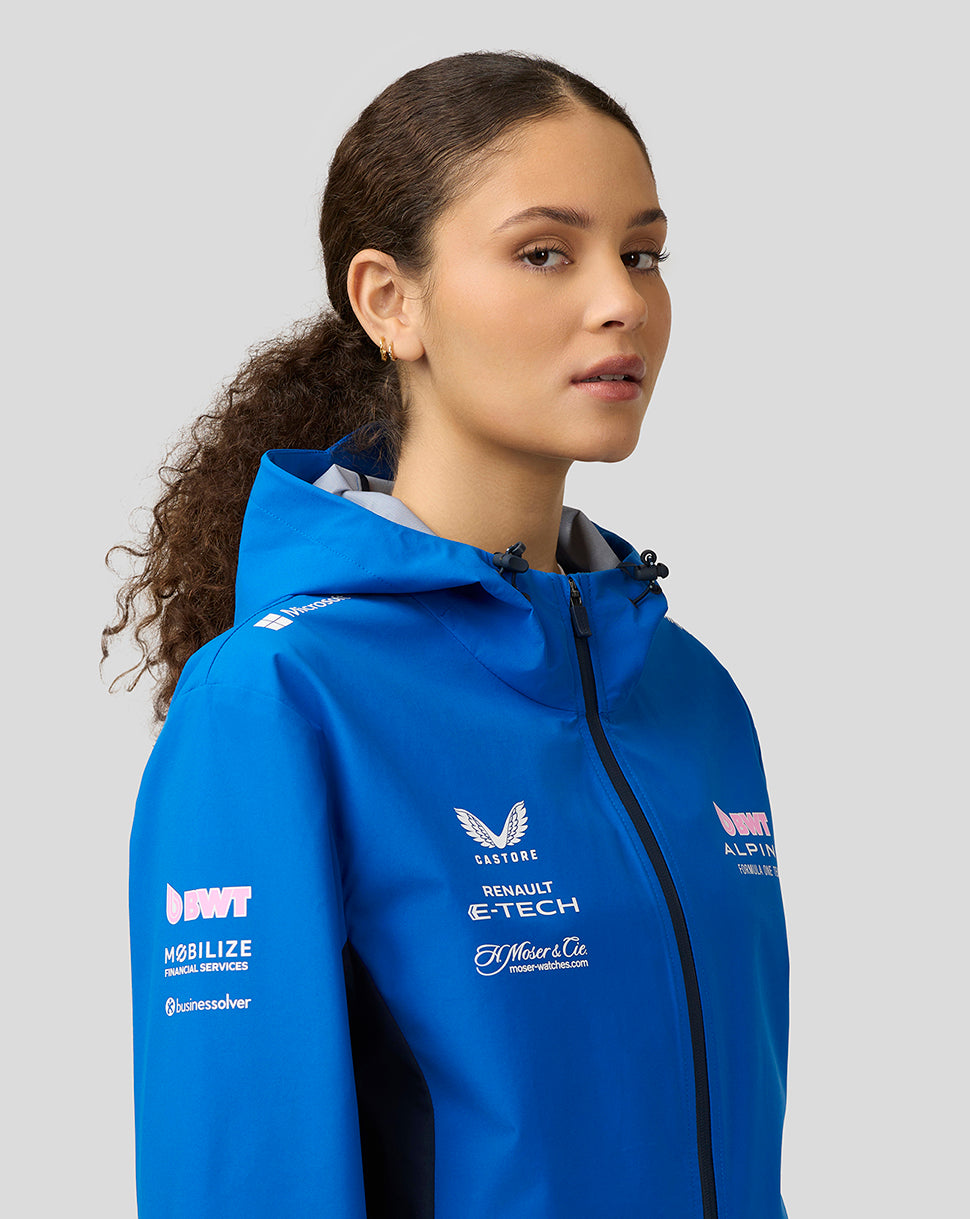 Close up of a female model wearing blue BWT Alpine water resistant jacket with hood and chest sponsor logos.