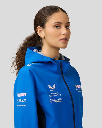 Close up of a female model wearing blue BWT Alpine water resistant jacket with hood and chest sponsor logos.