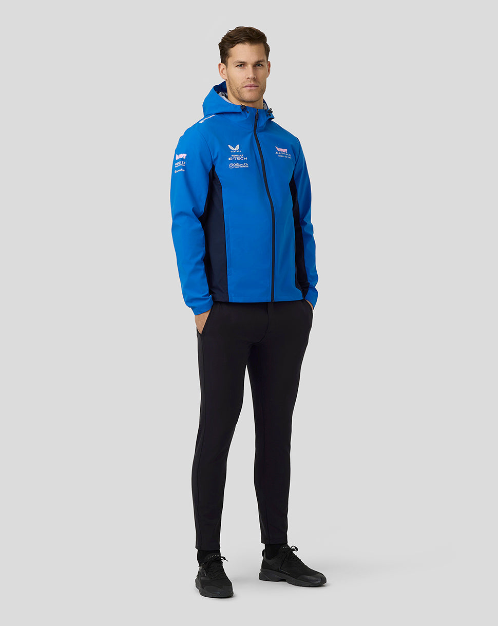 Male model wearing lapis blue BWT Alpine water resistant jacket with hood and center zip and sponsor logos
