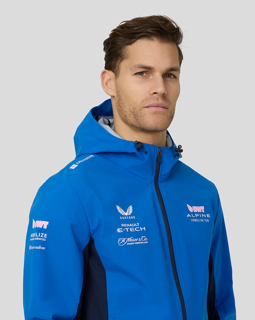 Male model wearing blue BWT Alpine water resistant jacket with hood and sponsor logos on the chest and sleeve.