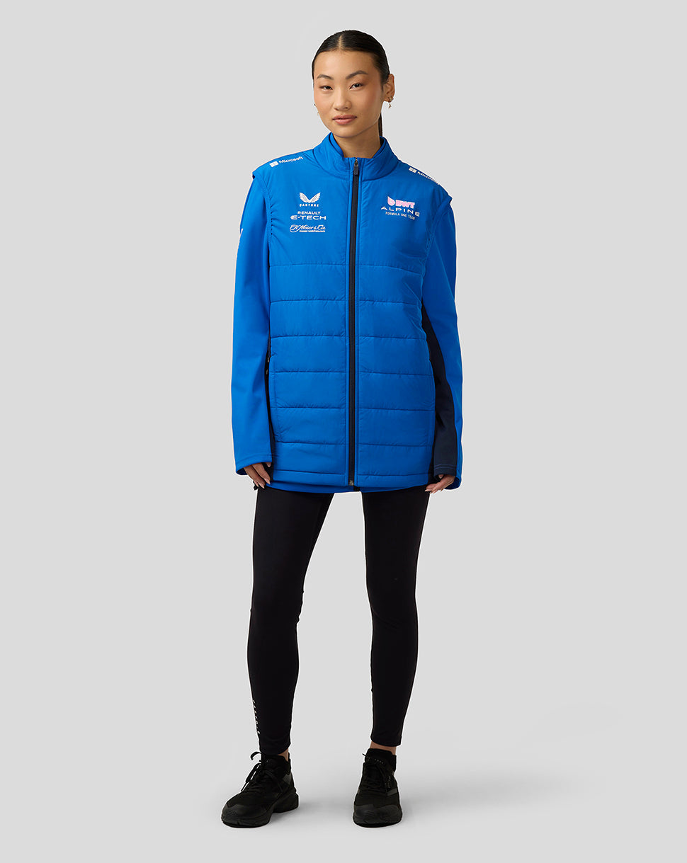 Person wearing lapis blue Alpine Formula One Team hybrid gilet with full zip, funnel collar and concealed pockets.