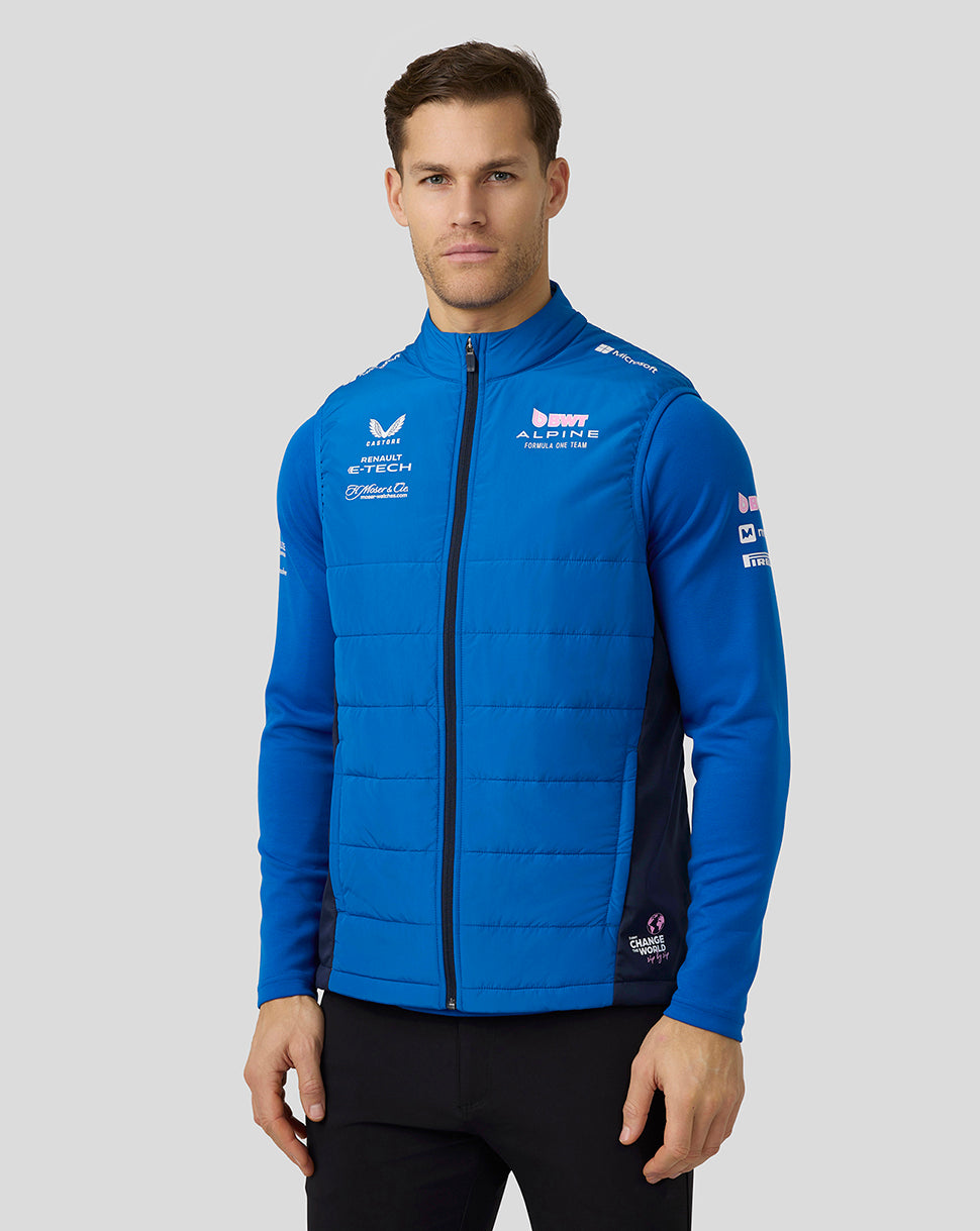 Model wearing lapis blue Alpine Formula One Team unisex Hybrid Gilet, a sleeveless padded vest with full front zip and funnel collar.