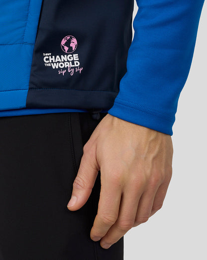 Close-up of the gilet back panel featuring a pink globe logo and Change the World sip by sip graphic.
