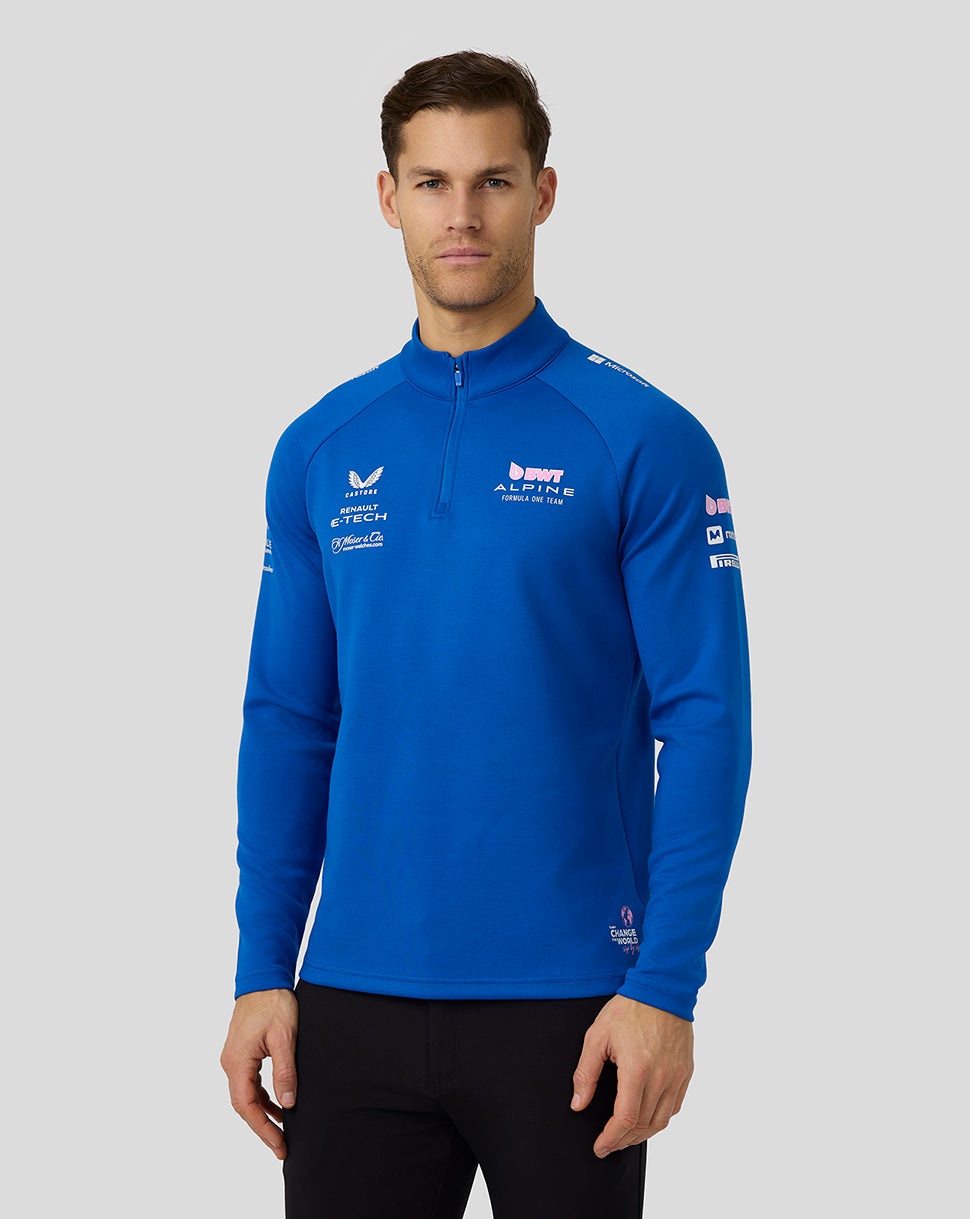 Front view of a male model wearing lapis blue BWT Alpine unisex quarter zip midlayer with funnel neck and team logos.