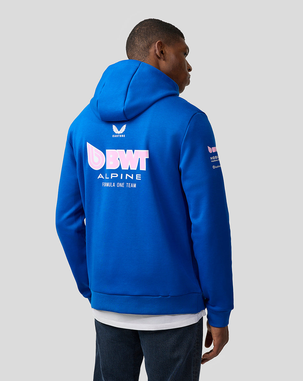 Male model seen from behind wearing lapis blue BWT Alpine hoodie with a large back logo