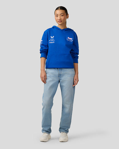 Female model in a royal blue BWT Alpine unisex pullover hoodie with chest logos, paired with jeans