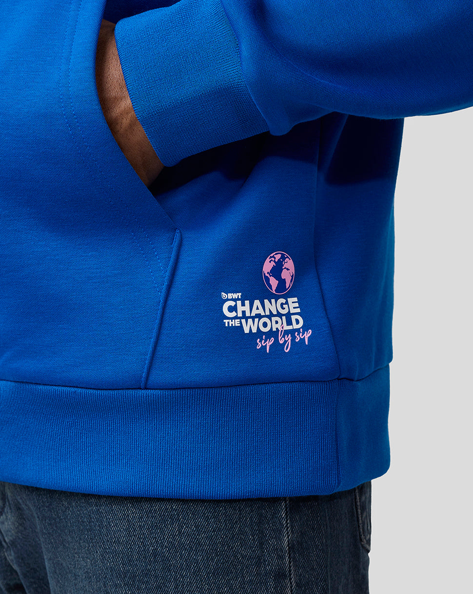 Close up of the blue hoodie pocket with a Change the World graphic and logos