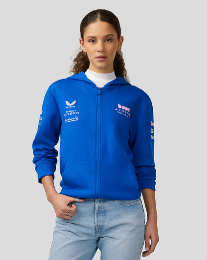 Female model wearing lapis blue BWT Alpine hoodie front view with zip closure and chest branding