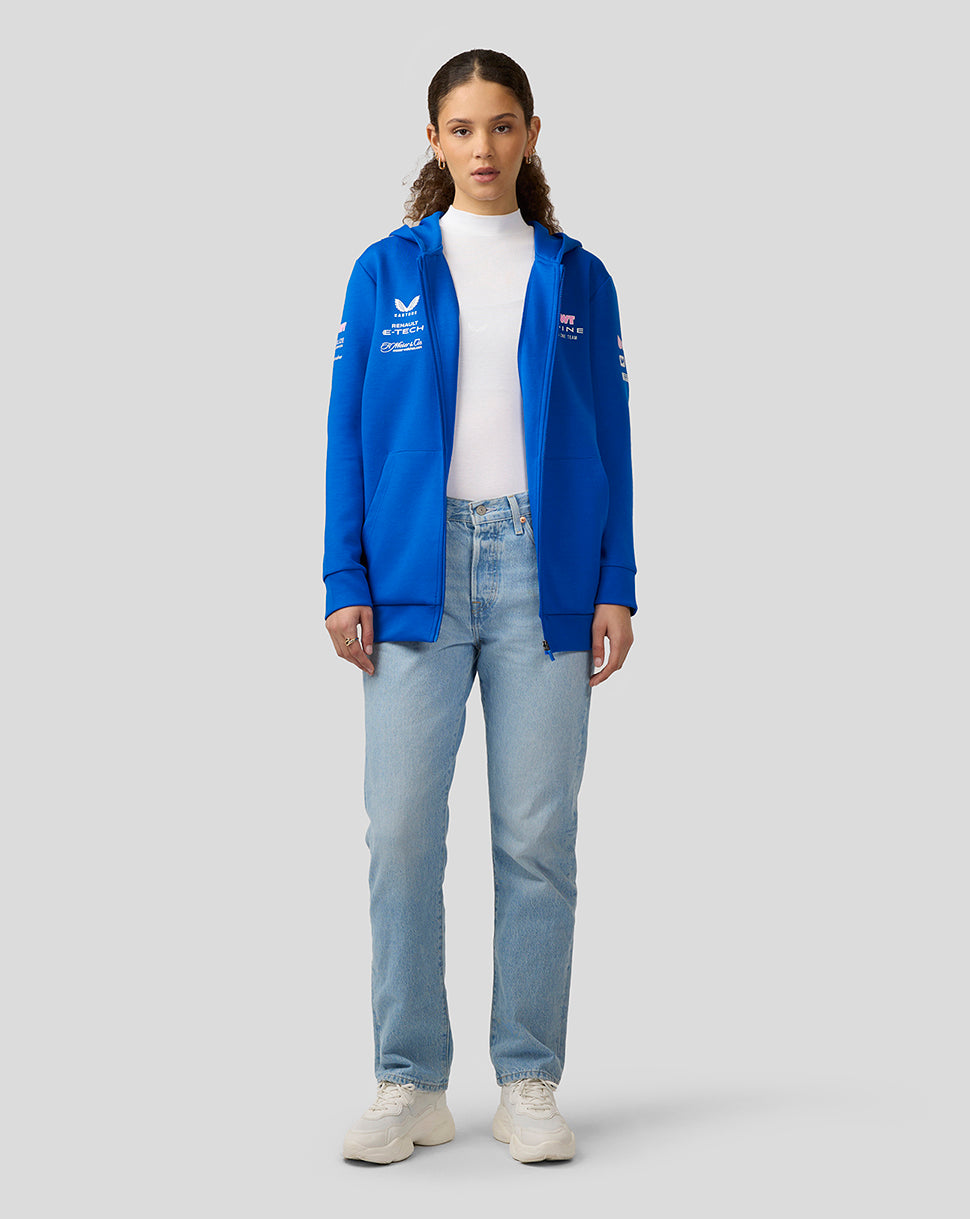 Front view of a female model in a lapis blue BWT Alpine Formula One Team full zip hoodie with logo patches on chest and sleeve
