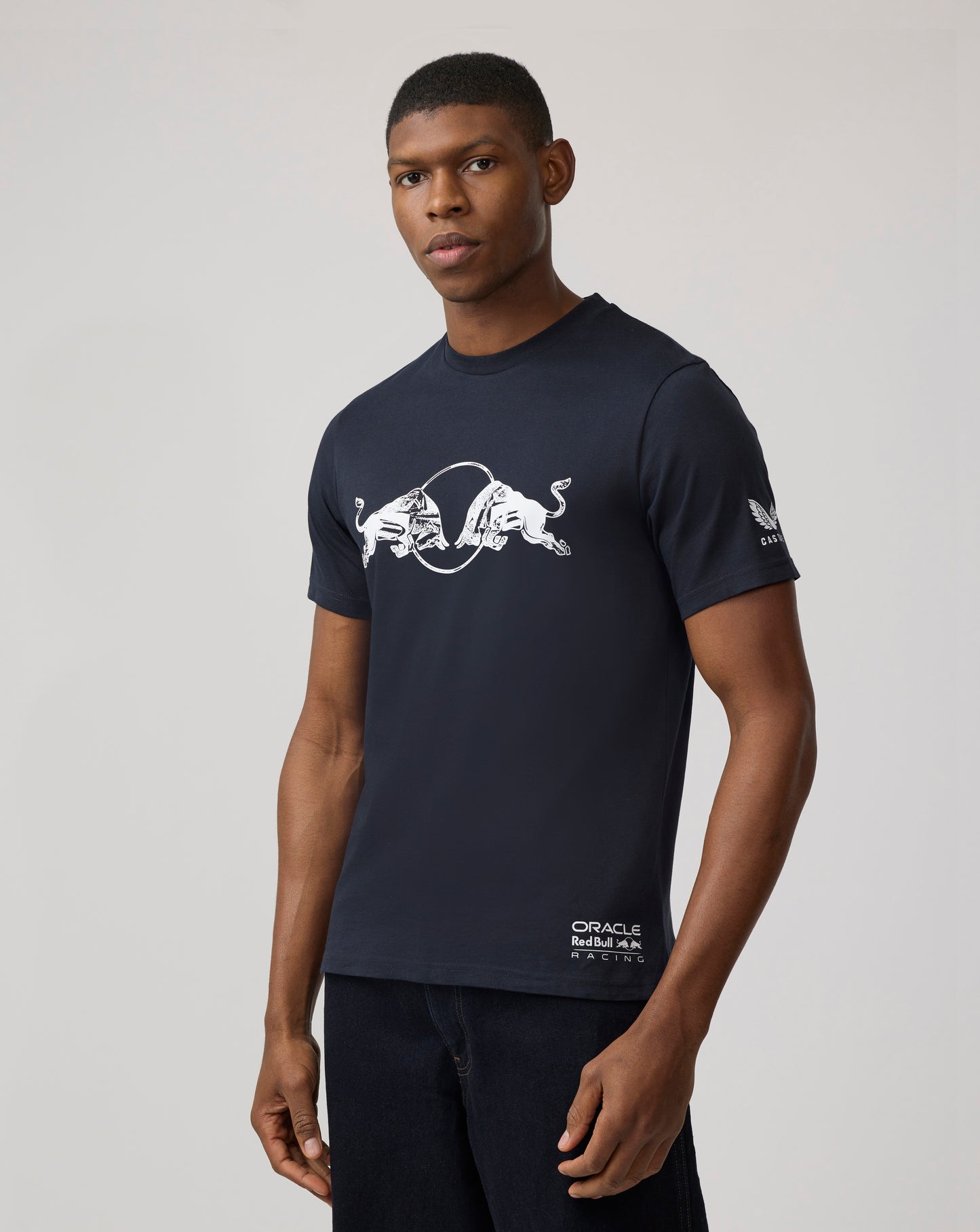 Male model wearing a navy Oracle Red Bull Racing graphic bull T shirt.
