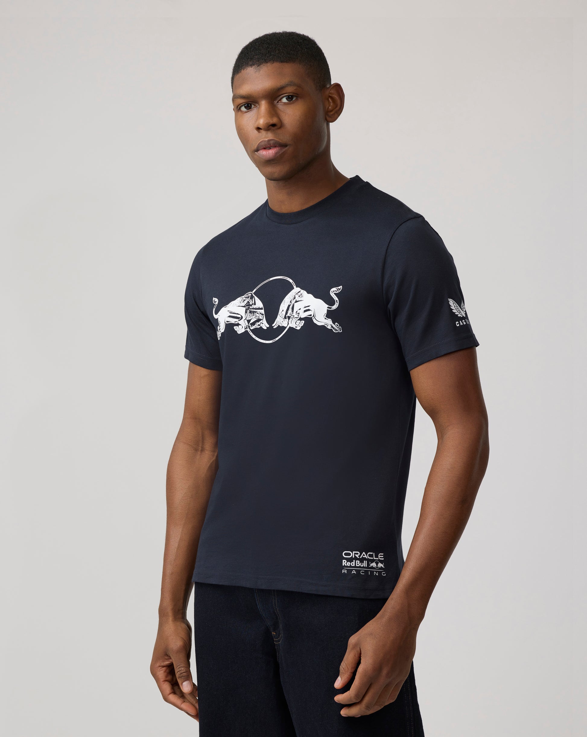 Male model wearing a navy Oracle Red Bull Racing graphic bull T shirt.