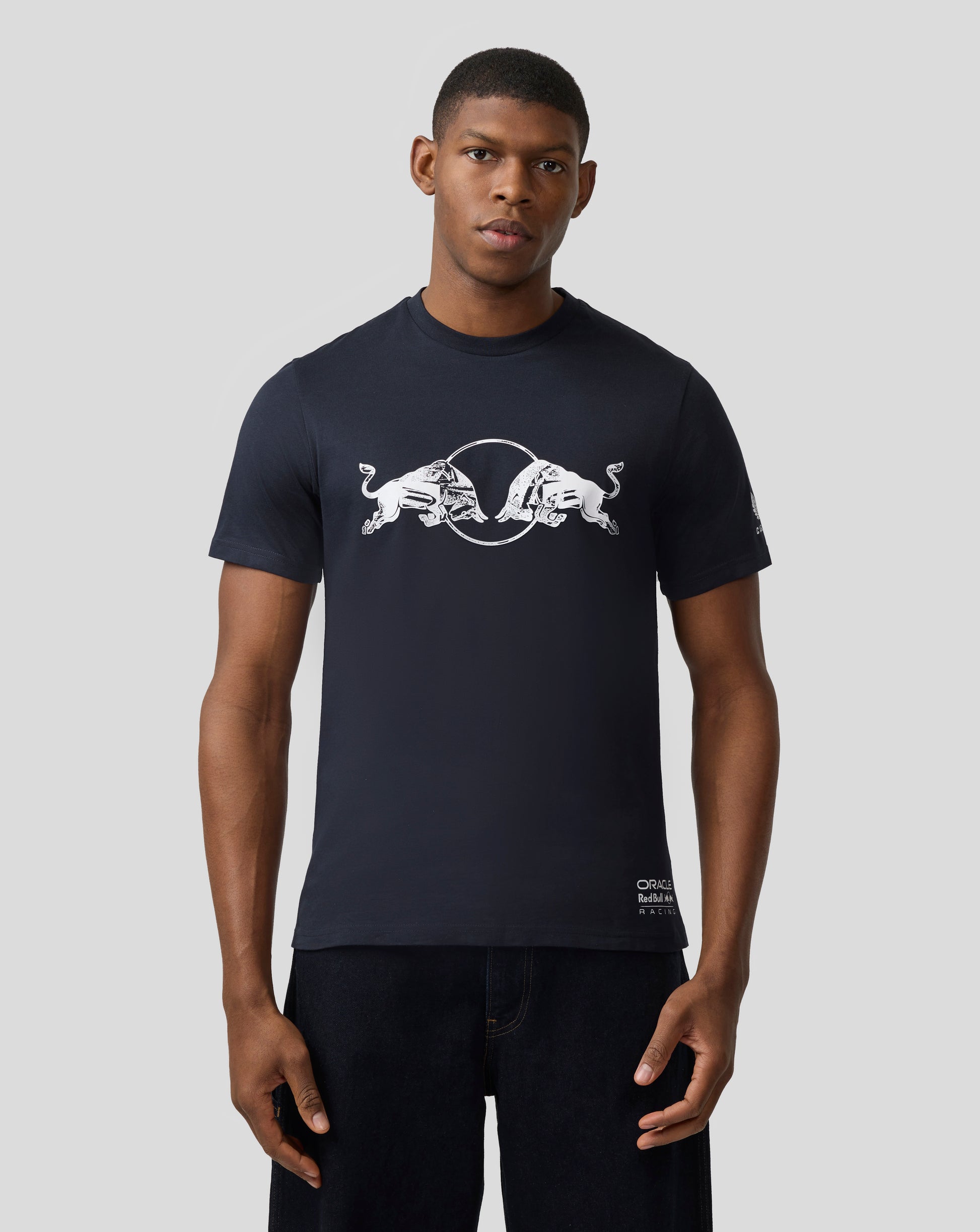 Male model wearing navy Night Sky Oracle Red Bull Racing graphic bull T shirt with a white bull logo across the chest.