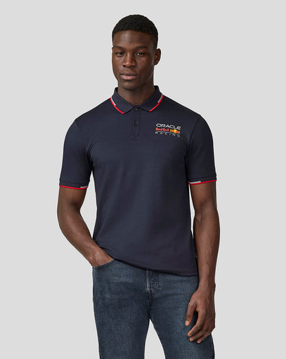Model wearing navy Night Sky Oracle Red Bull Racing Core Polo with chest logo and red piping on collar.