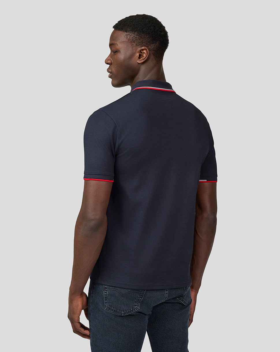 Back view of navy polo showing red piping on collar and sleeve cuffs