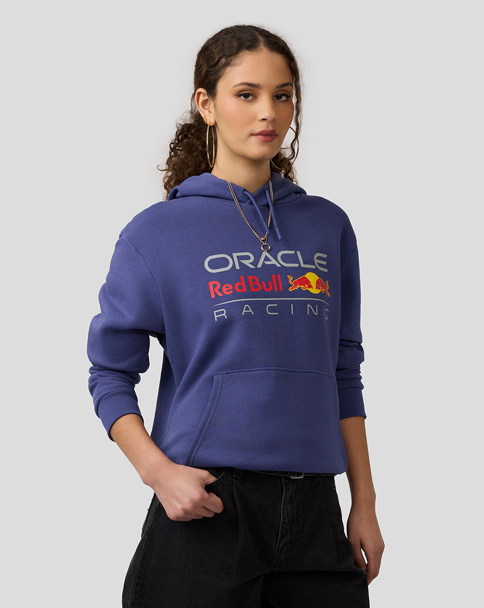 Female model wearing Skipper Blue Oracle Red Bull Racing hoodie with front logo and kangaroo pocket.