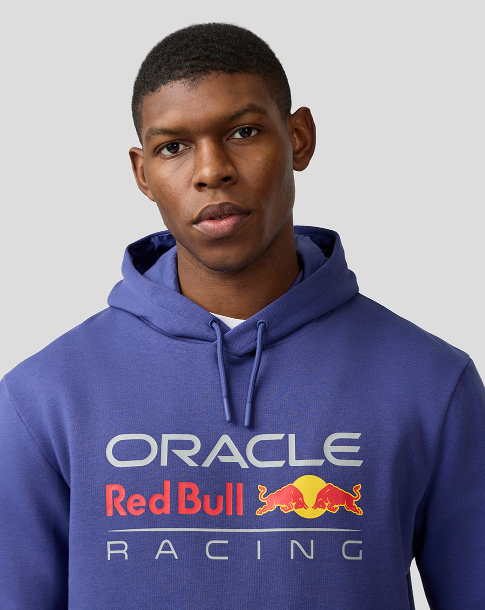 Male model wearing Skipper Blue Oracle Red Bull Racing hoodie with large front logo and kangaroo pocket.