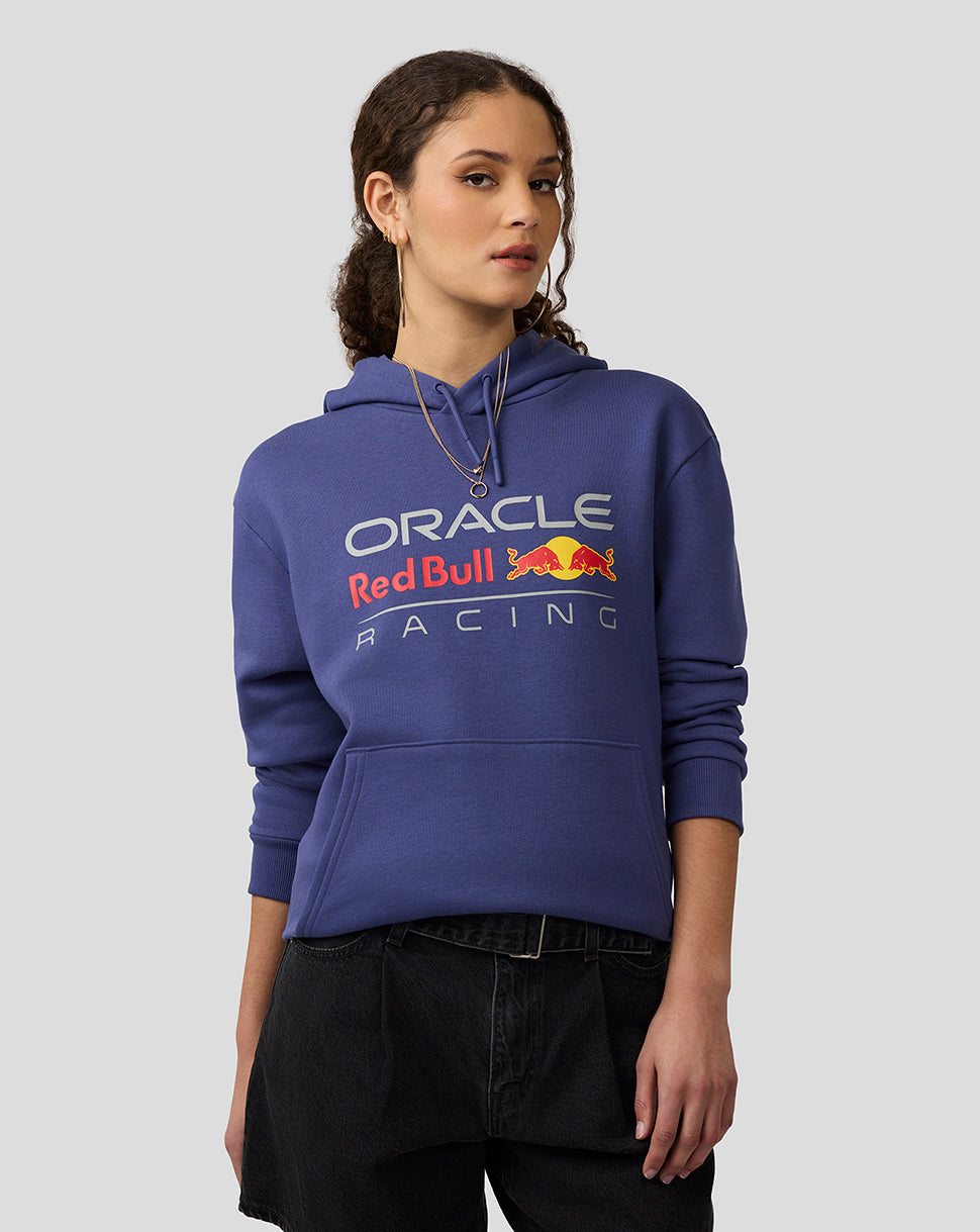 Model in Skipper Blue Oracle Red Bull Racing unisex Core Hoodie with large front logo