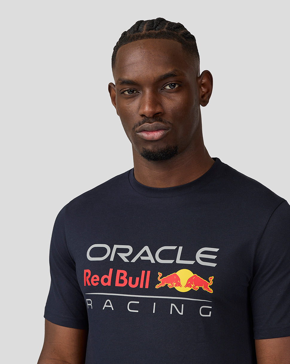 Close up of a man wearing navy blue Oracle Red Bull Racing T shirt with large front graphic.