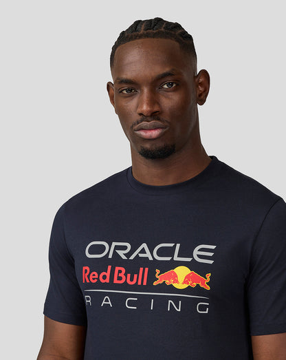 Close up of a man wearing navy blue Oracle Red Bull Racing T shirt with large front graphic.