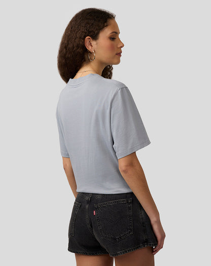 Back view of a woman wearing a light gray Oracle Red Bull Racing T shirt.