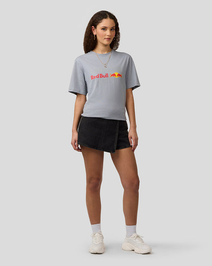 Female model wearing a light gray Oracle Red Bull Racing T shirt with Red Bull logo and a black denim mini skirt.