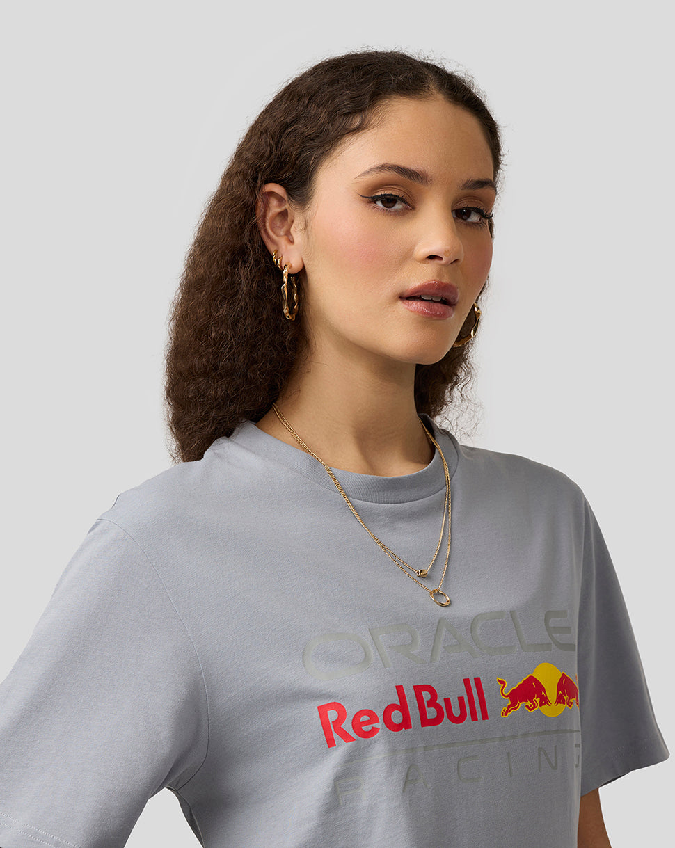 Model wearing a light gray Oracle Red Bull Racing T shirt with a large front logo graphic.