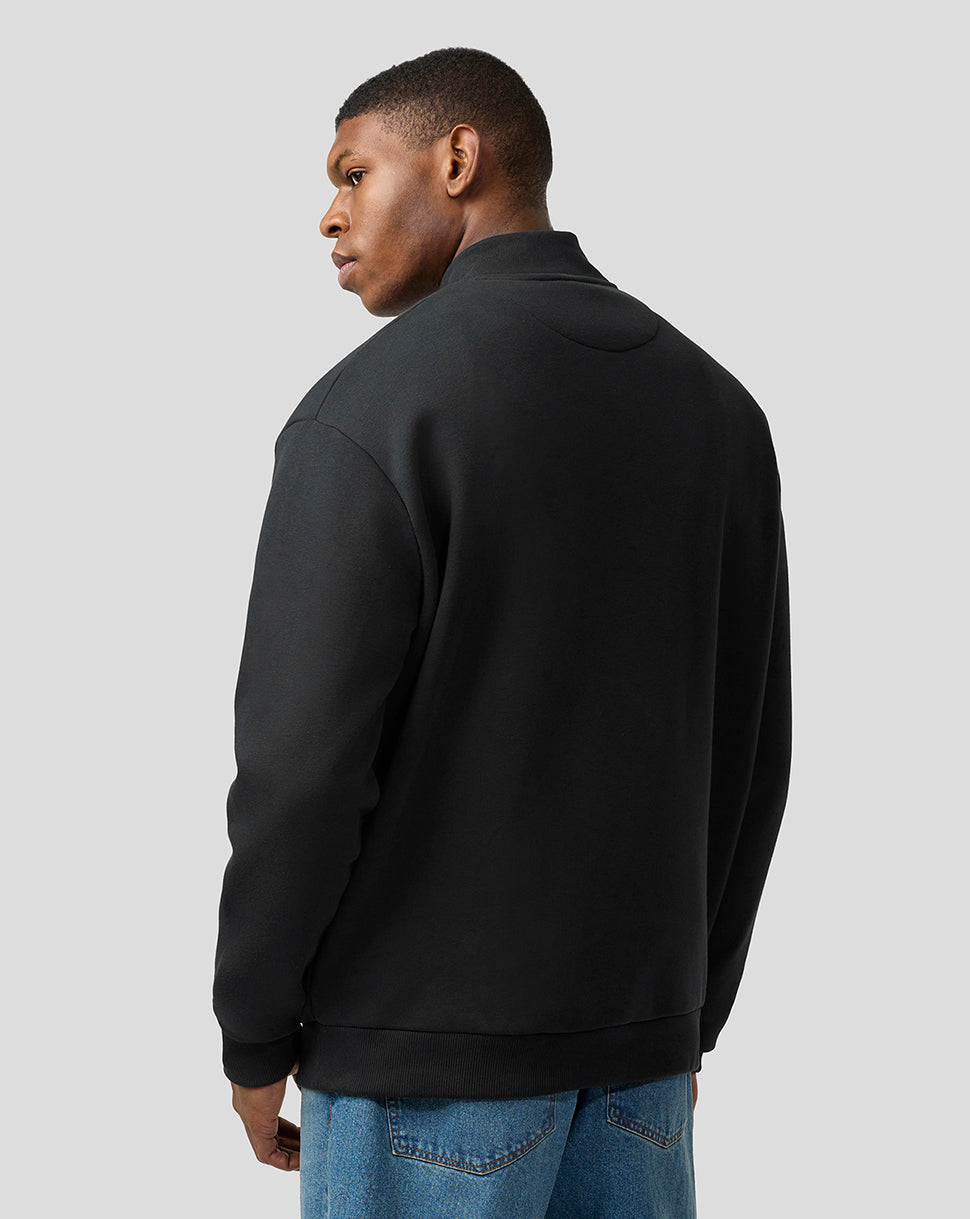 Back view of a black unisex Alpine dual brand quarter zip pullover with a relaxed oversized fit.