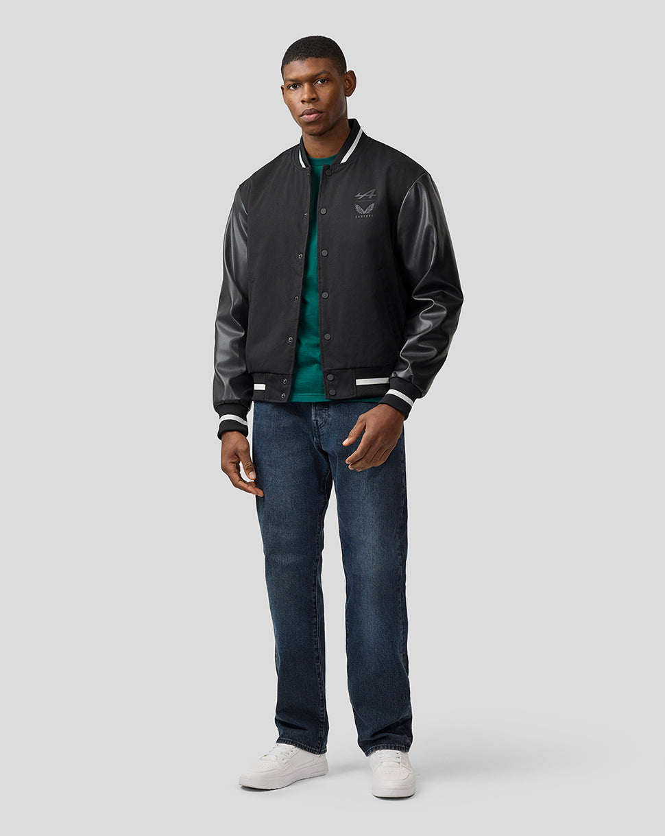 Male model wearing BWT Alpine unisex bomber jacket with black body and leather sleeves