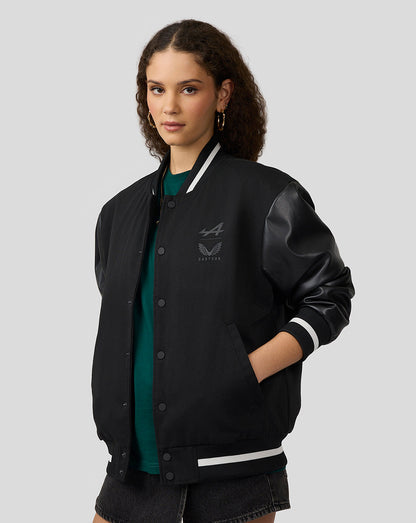 Model wearing Alpine black bomber jacket with leather sleeves and white striped cuffs