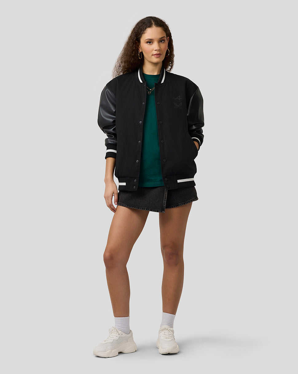 Female model wearing BWT Alpine unisex bomber jacket with black body and leather sleeves