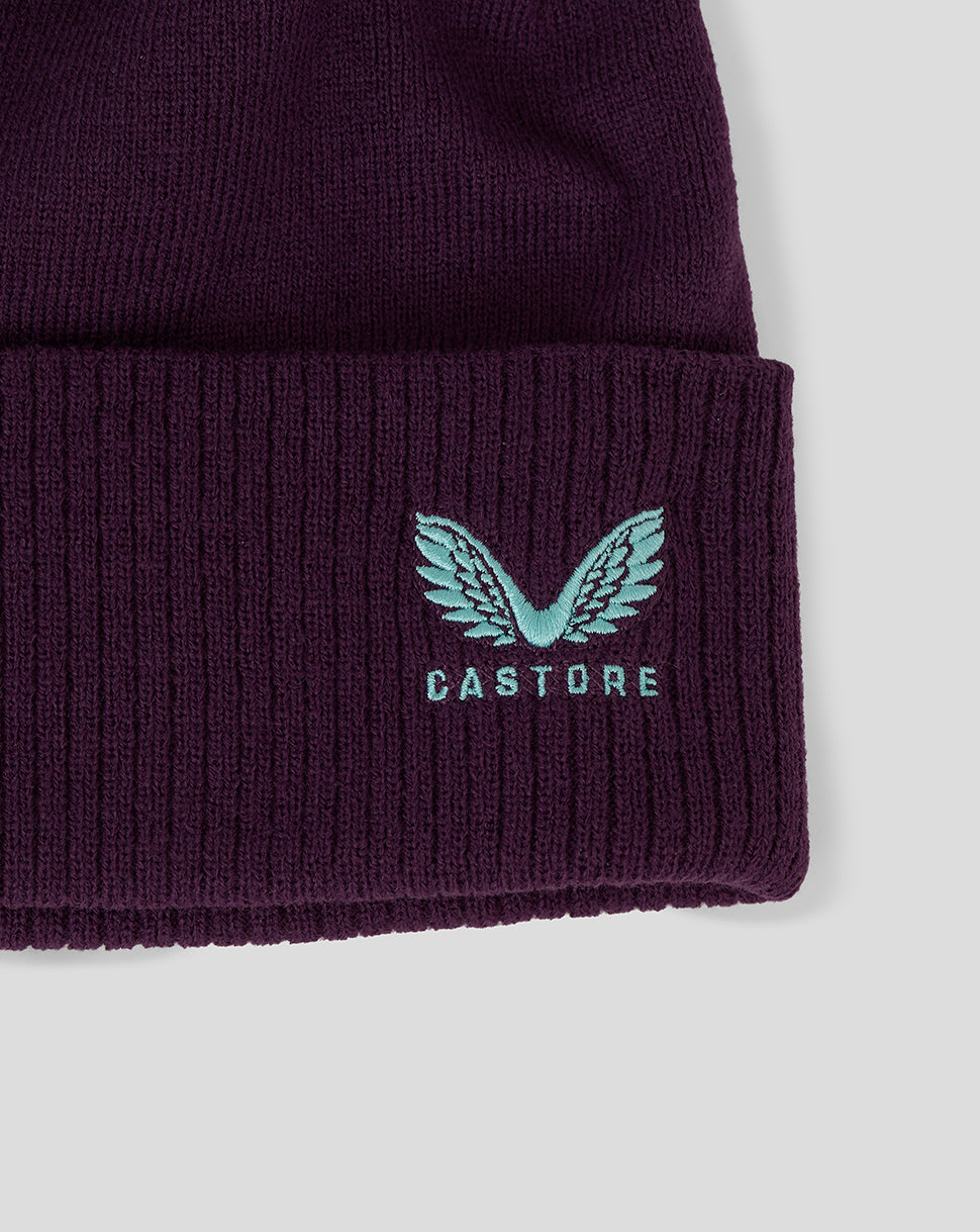 Close up of ribbed cuff showing teal crest embroidery and Castore logo on purple England Cricket beanie