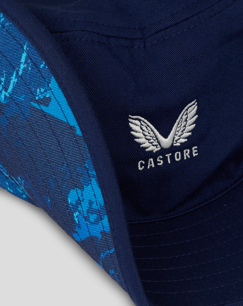 Close-up of navy wide brim hat showing white Castore wing logo on front.