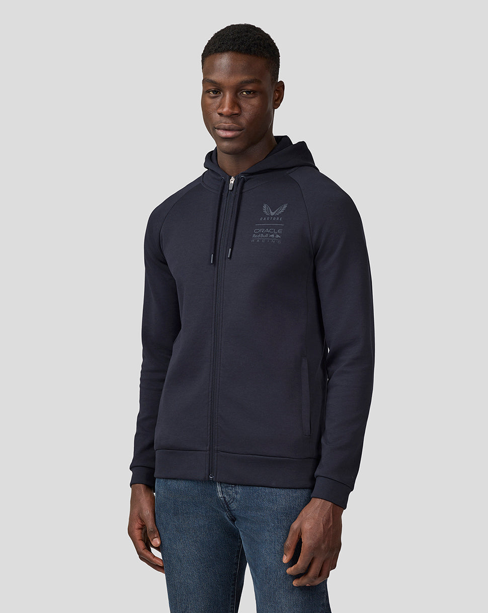 Front view of a man wearing a night sky navy unisex full zip hoodie with a drawstring hood and chest logo.