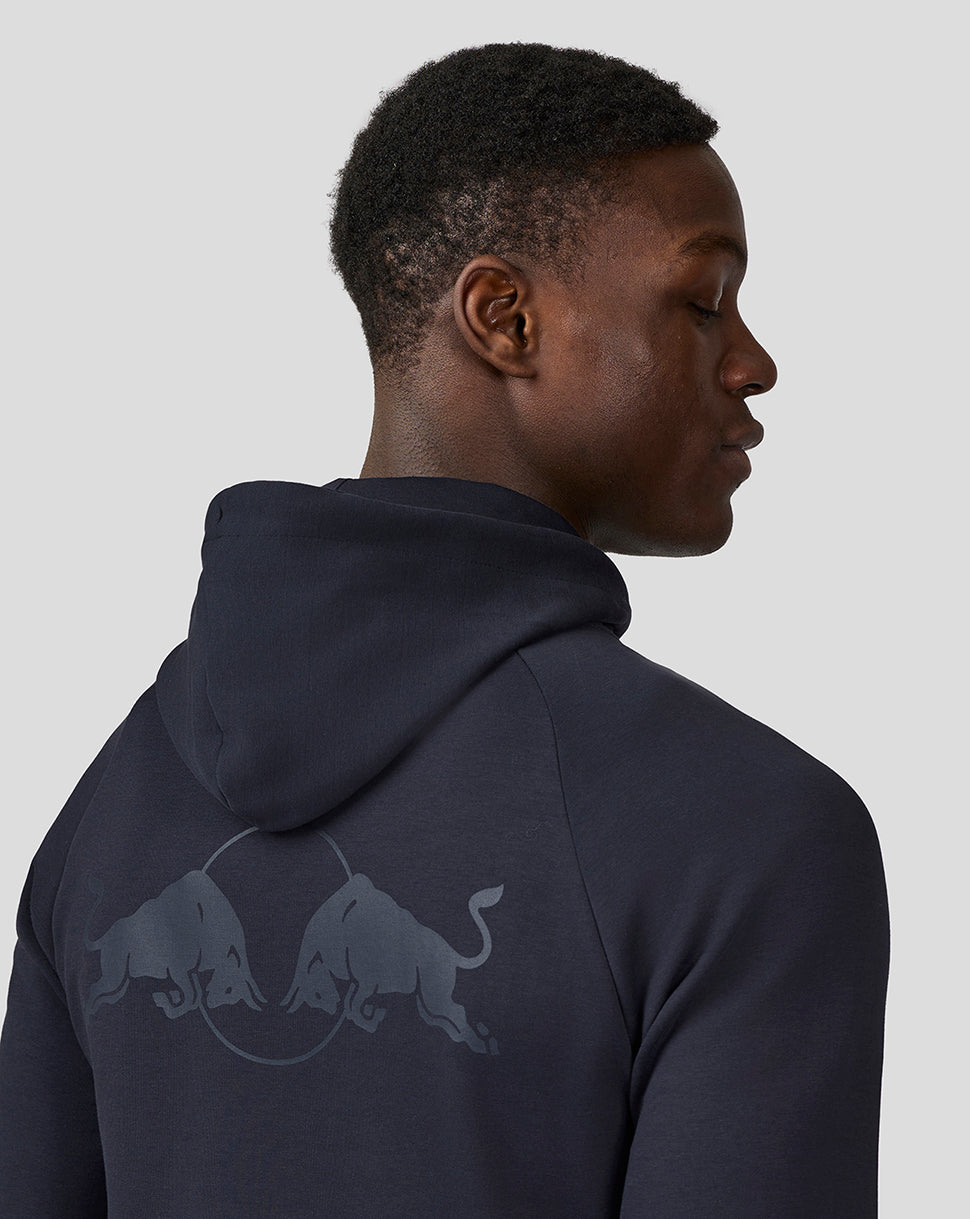 Back view of a man wearing a night sky navy full zip hoodie with a large Red Bull graphic on the back.