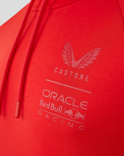 Close up of chest area on flame scarlet hoodie revealing a pale logo and Castore branding.