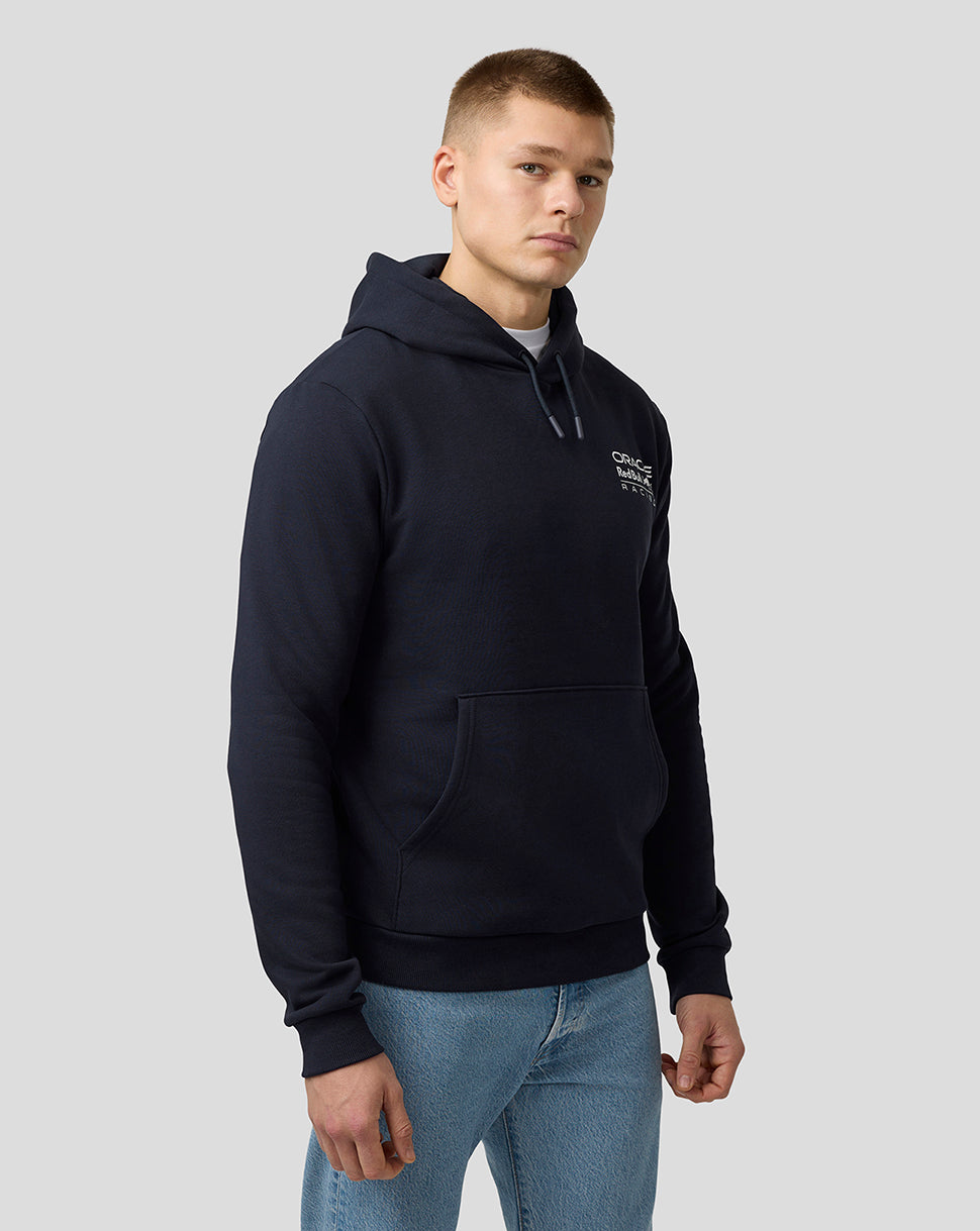 Male model in night sky navy Oracle Red Bull Racing Crest pullover hoodie with a small chest logo and a large front kangaroo pocket.