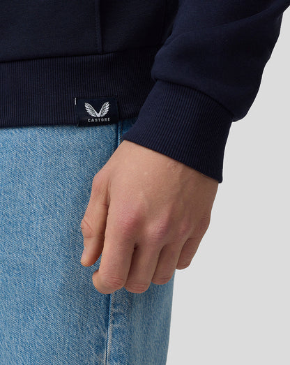 Close up of navy hoodie cuff with a Castore label and jeans in view