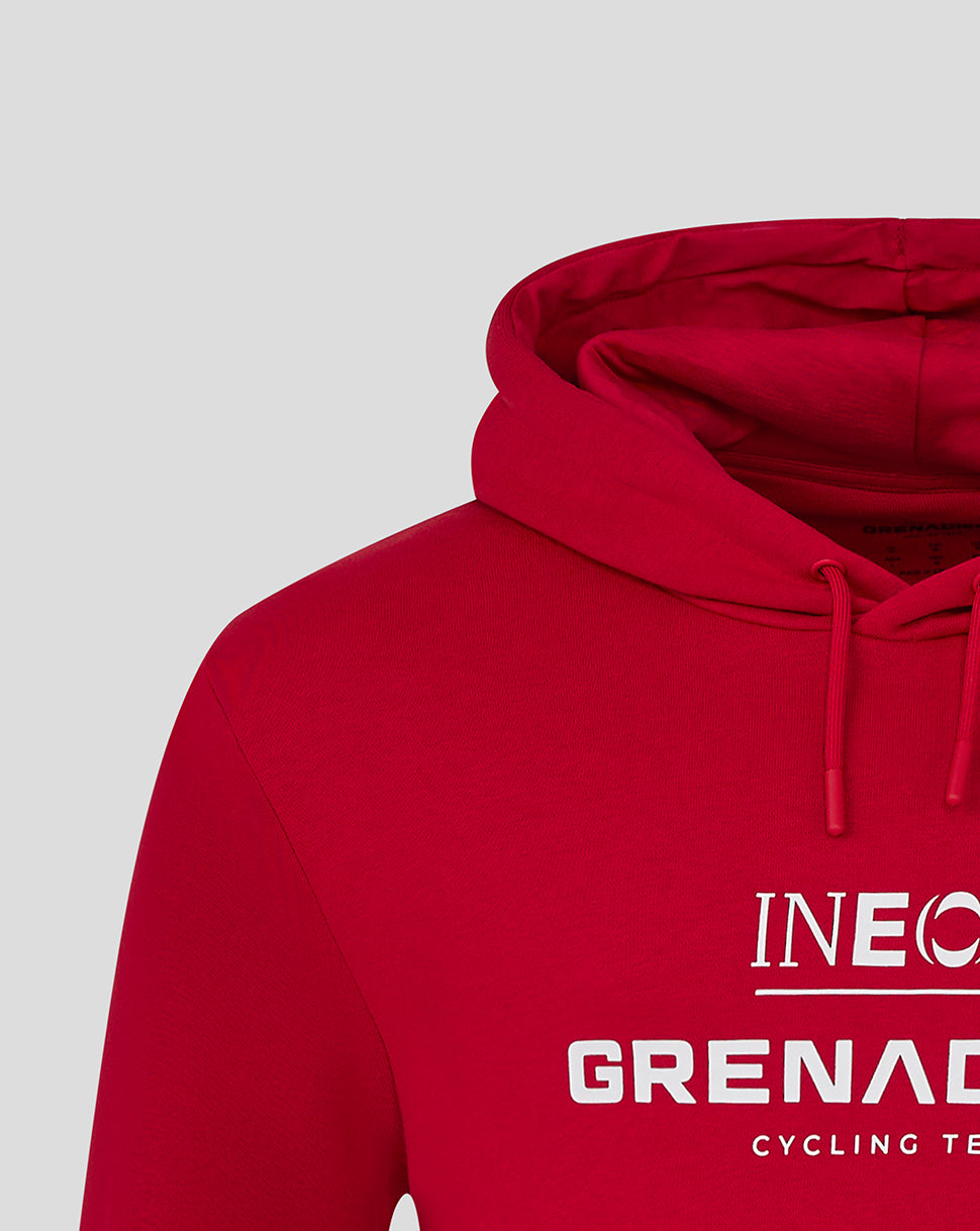 Close-up of red hooded sweatshirt showing INEOS Grenadiers logo on the chest and drawstring hood.