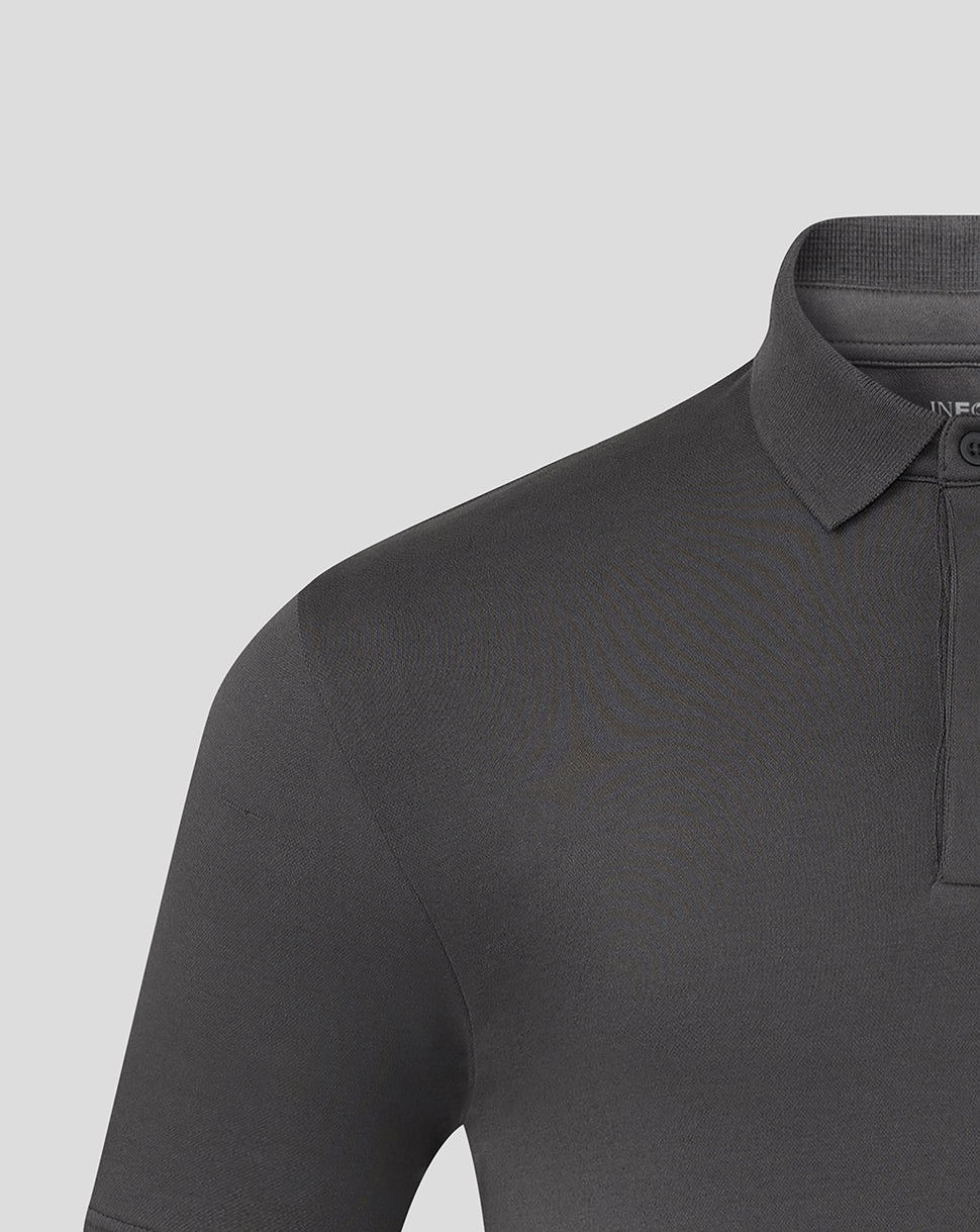 Close up of the front upper torso of the grey polo showing collar and hidden button down placket