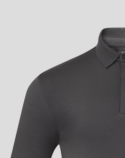 Close up of the front upper torso of the grey polo showing collar and hidden button down placket