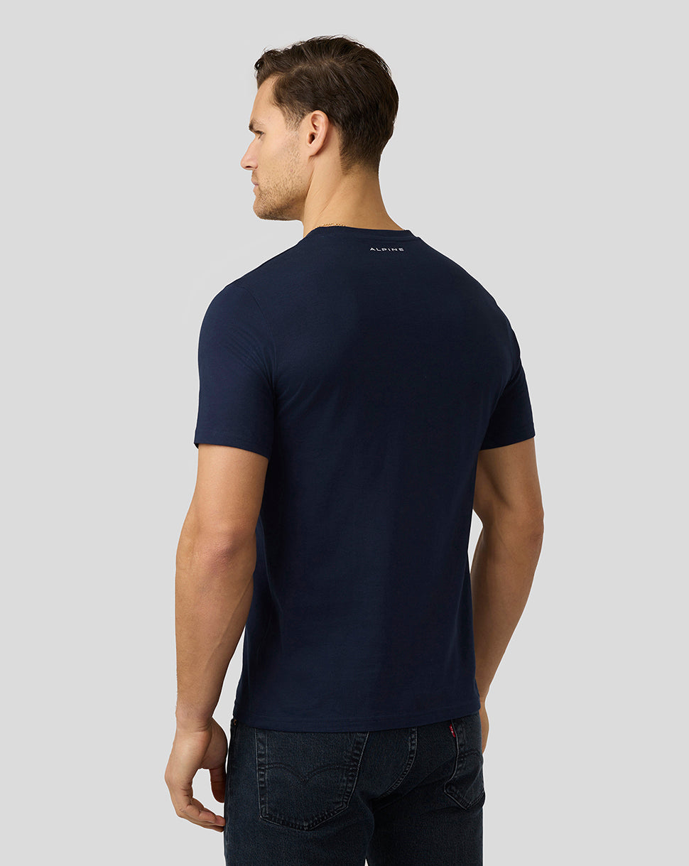 Male model seen from behind in a navy Alpine Core Essentials T-Shirt with a small logo at the upper back.