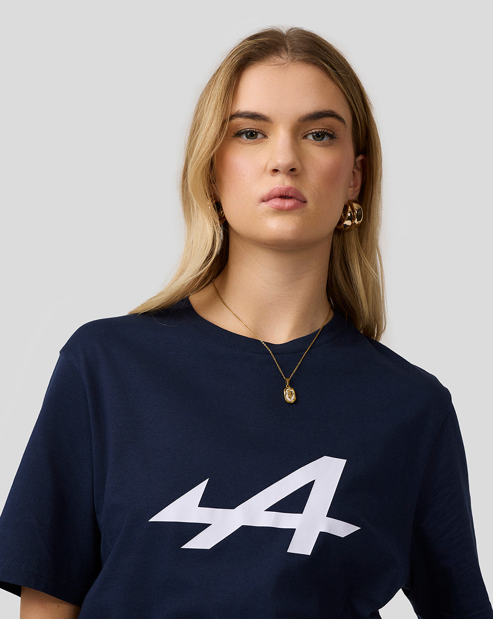 Female model wearing navy Alpine Core Essentials T-shirt with a bold white logo on the chest.