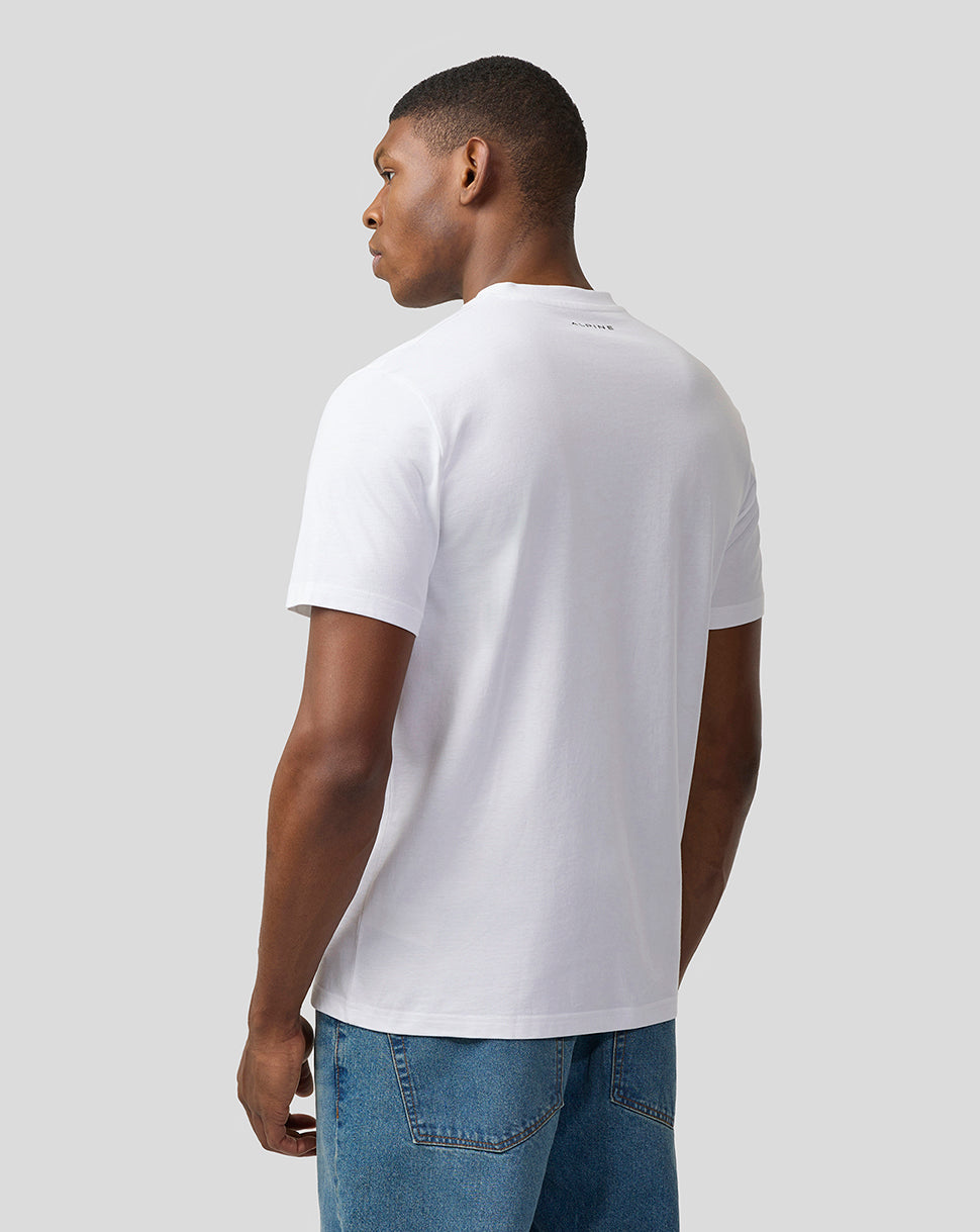 Back view of a person in white Alpine Core Essentials T-Shirt showing a small logo at the neckline