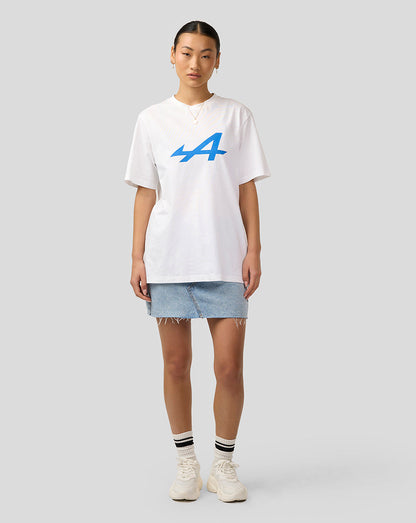 Front view of Alpine Unisex Core Essentials T-Shirt in Brilliant White with bold blue logo on the chest worn by a model in a denim skirt